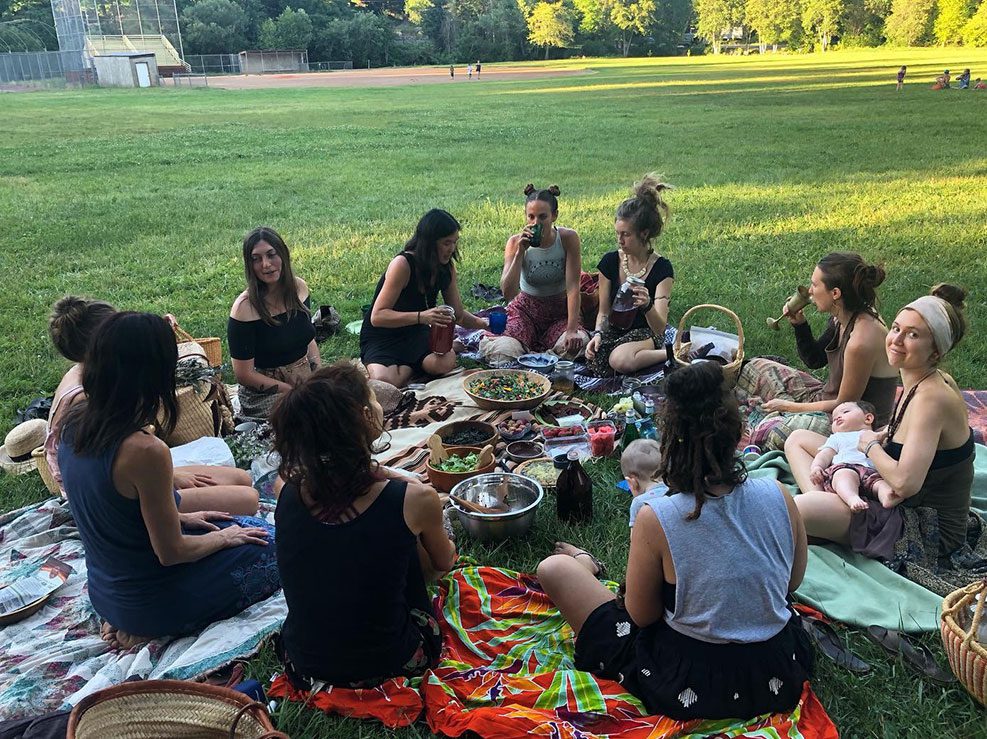 A group of people sitting on the grass