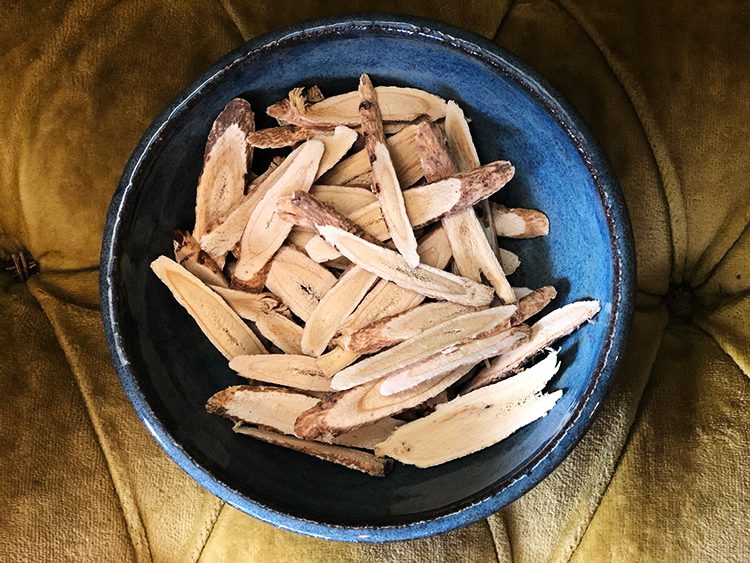 A bowl of food that is on the table.