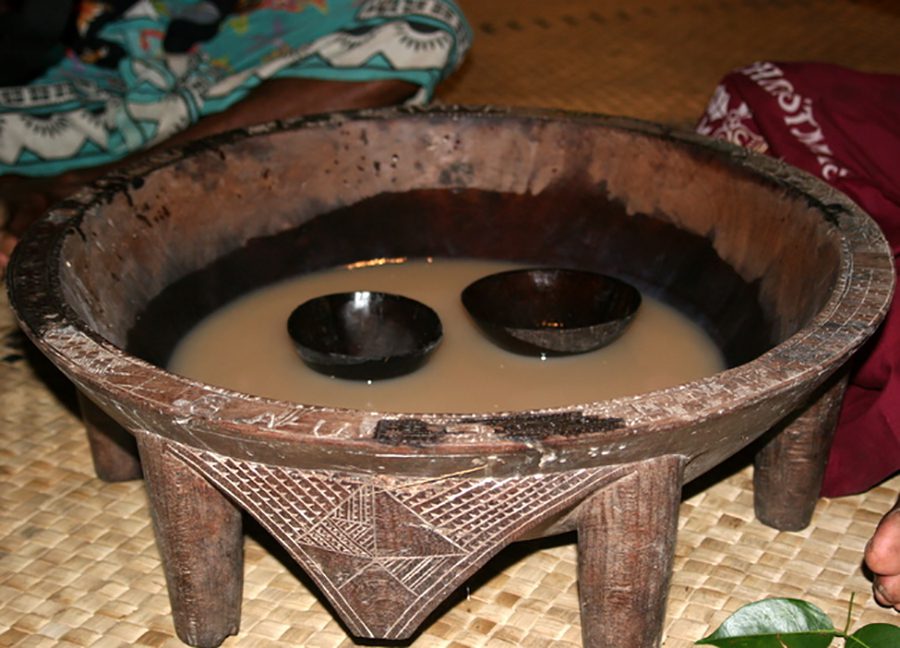 A bowl of water and two candles in it.