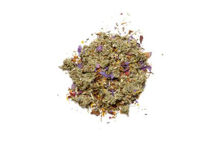 A pile of dried herbs and flowers on top of white background.