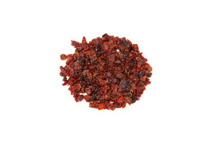 A pile of dried fruit on top of a white background.