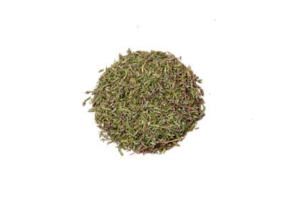 A pile of green tea leaves on top of a white surface.