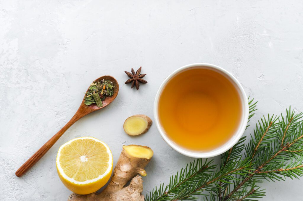 A cup of tea with lemon, ginger and spices.