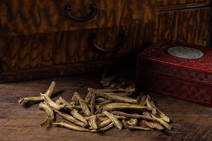 A pile of dried sticks on top of a wooden table.