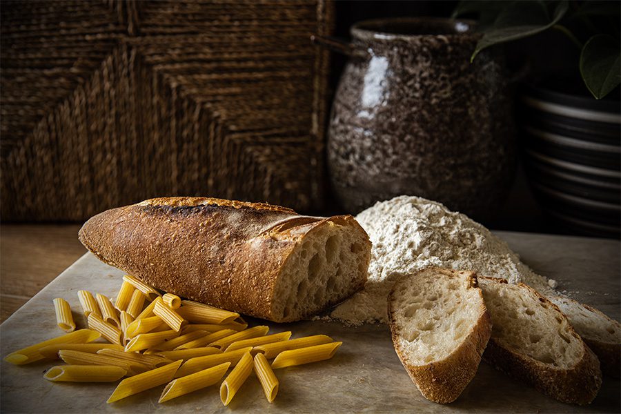 A loaf of bread and some french fries on the table