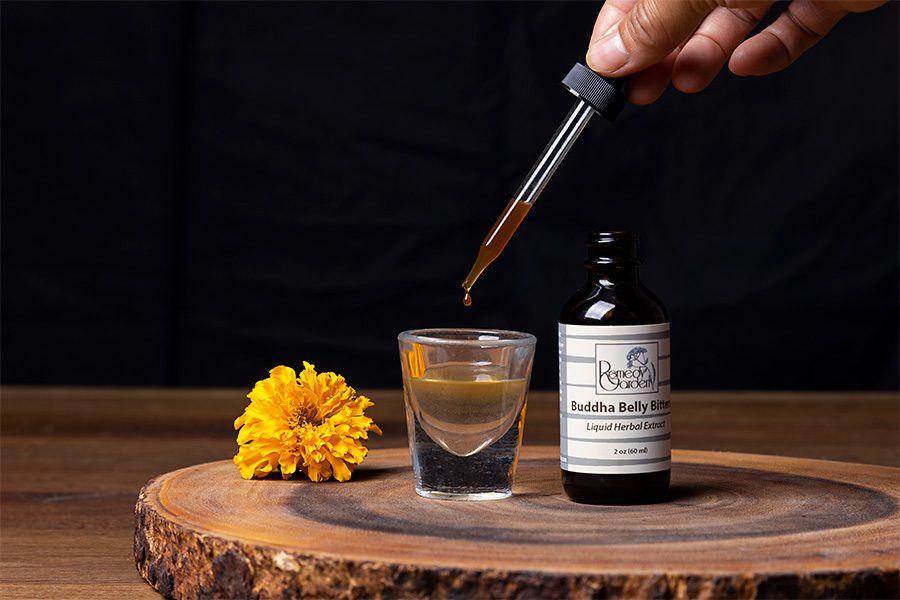 A person is pouring liquid into a shot glass.